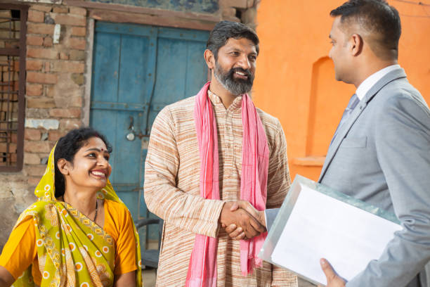 Happy dairy farmers with cows in green pasture